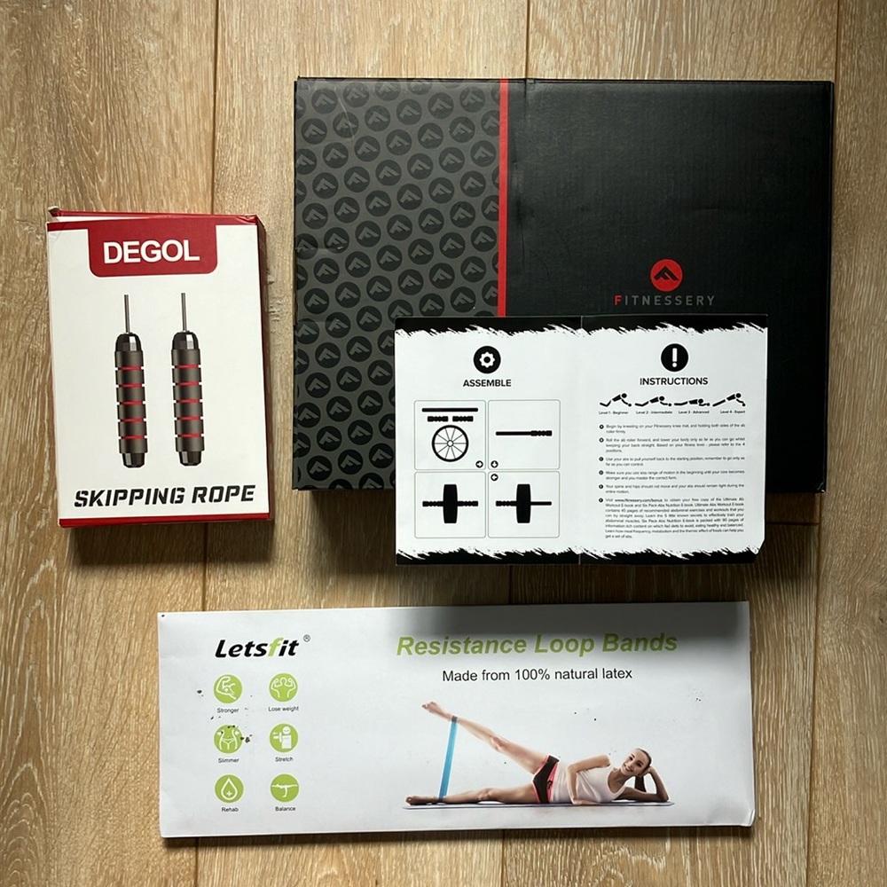 Portable home gym includes Jump rope, ab roller and bands. All new in packaging